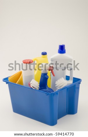 Household cleaning products used to clean bathrooms and kitchens in a container. White background.