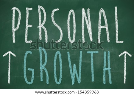Personal growth phrase handwritten on the chalkboard with rising arrows