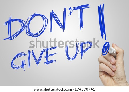 Don\'t Give Up hand writing with a blue marker on a white board