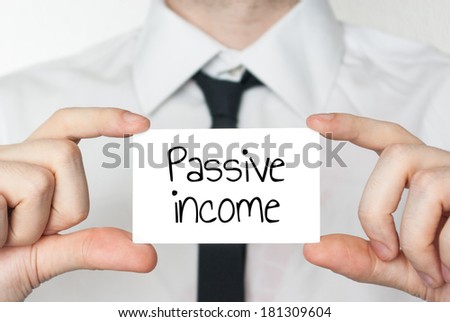 Businessman holding or showing card with text passive income