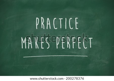 Practice makes perfect handwritten on school blackboard