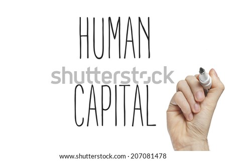 Hand writing human capital on a white board