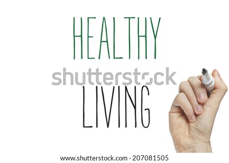 Hand writing healthy living on a white board