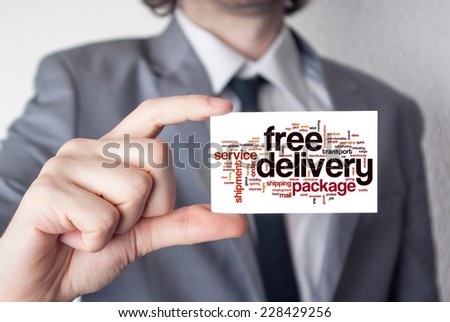 Broker. Businessman in suit with a black tie showing or holding business card.