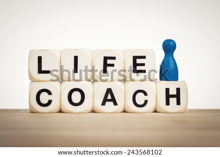 Coaching concept: Blue pawn next to word Life coach spelled by toy dice