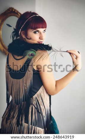 Retro portrait of beautiful woman with a feather in vintage style. Fashion photo, Gatsby Style