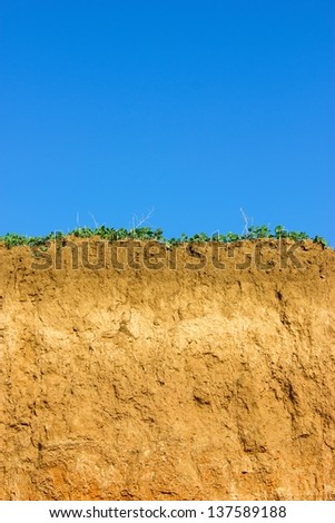 Soil cross section, green grass and blue sky