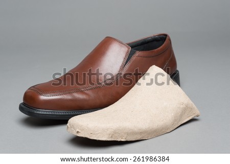Men\'s dress shoes are sometimes packaged with cardboard inserts that prevent the shoe from getting deformed.