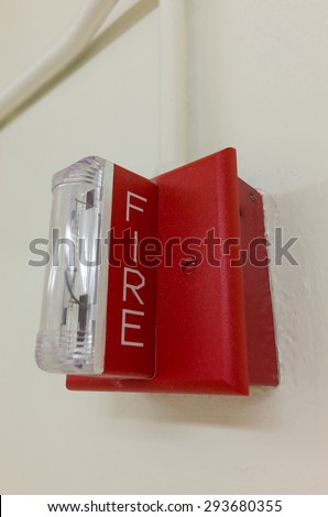 A fire alarm light on a wall. When flashing, it signals the need to evacuate the building.