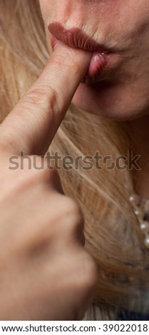 A woman sucks on the tip of her finger
