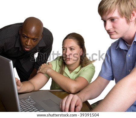 A diverse group of young people gather around a laptop computer to look at something interesting on the screen
