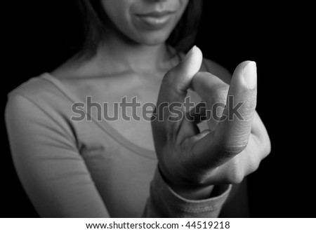 A dark-complexioned woman gesturing \