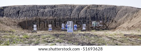 Targets set up in front of a mound of dirt for target practice