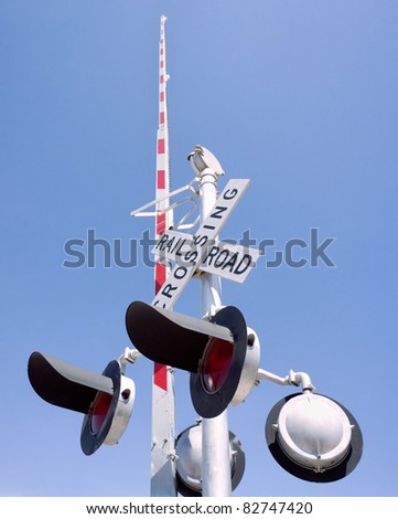 Guard rail and warning lights at railroad crossing