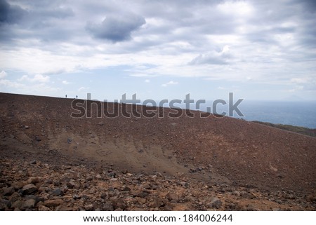 Two silhouettes on the edge of the Grand Crater, island Volcano, Lipari Islands, Sicily
