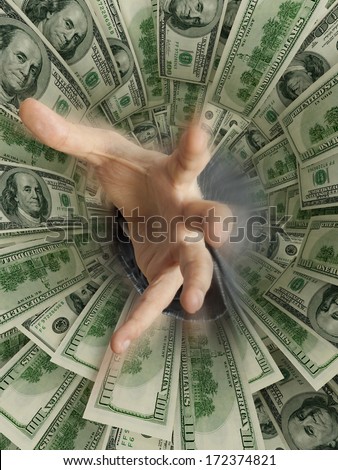 hand drowning in money hole (Shallow DOF)