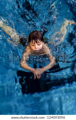 little boy on swimming lesson