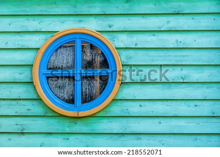 colorful round window on wooden surface.