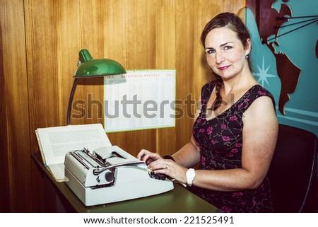 Secretary in a sixties style office, with old typewriter.