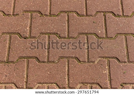 Abstract geometric background of brown paving slabs in a trapezoid shape, laid out on the pavement