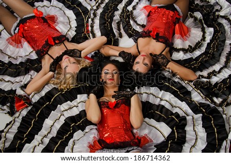 Three young girls dancing in studio a french cancan