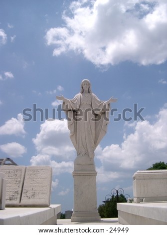 A statue of the Virgin Marywith the arms wide open.