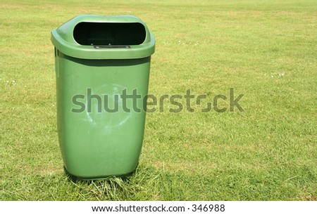 A trash can with grass background