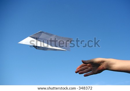 a paper plane that was just thrown in the air. Symbolizes concepts like success, independence or freedom