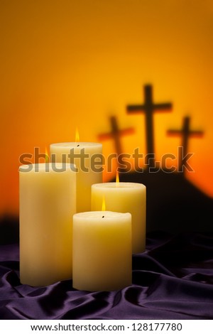 Three crosses symbolic for Jesus crucifixion in Golgotha and candles of hope Three crosses symbolic for Jesus crucifixion in Golgotha and candles of hope