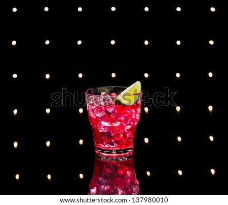 Red Campari Cocktail in short glass with lemon decoration