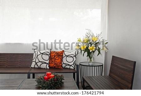 Patio lounge with garden bench and flower decoration