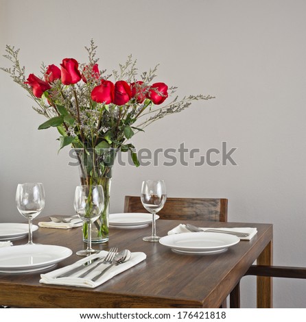 Dinner Table Setup For Four With Red Roses