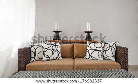 Beige brown sofa in luxurious interior setting and beautiful pillows