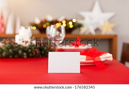 Christmas dinner table setting with name card in red