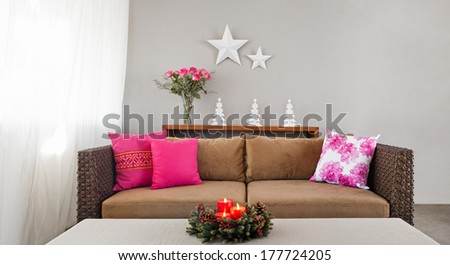 Beige upholstered sofa with advent flower arrangement
