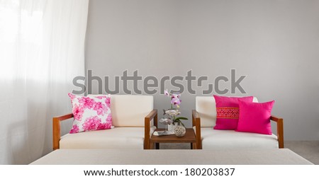 Bright sofa seat in luxury interior decoration with orchids