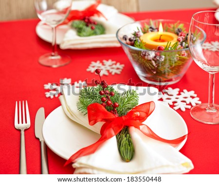 Red Christmas dinner table setup with snow flake decoration