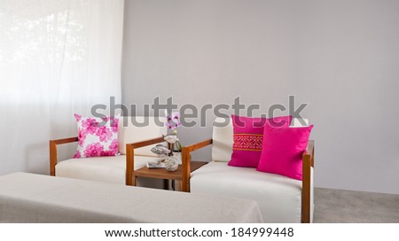 Bright sofa seat in luxury interior decoration with orchids