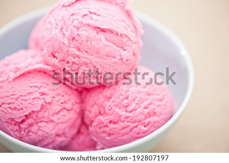 Raspberry ice cream cup over beige background