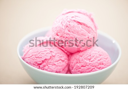 Raspberry ice cream cup over beige background