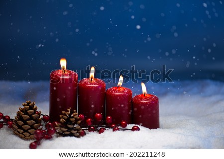 4th Advent candle in snow and snowfall
