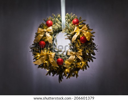 Advent wreath over silver grey background with red bauble