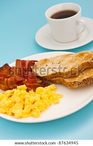 American breakfast, bacon and scrambled egg, with a cup of coffee