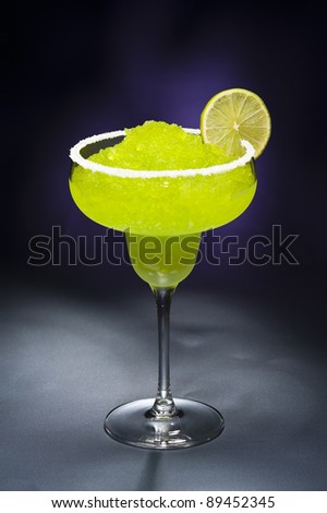 Classic margarita cocktail in front of different colored backgrounds