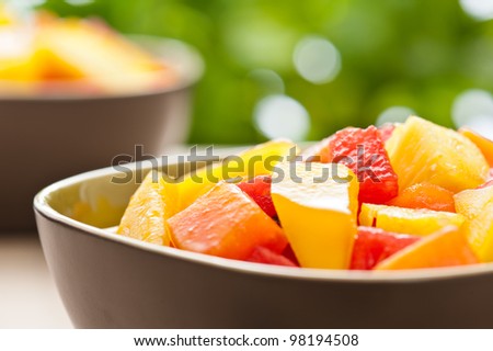 One bowl of Mixed tropical fruit salad in front of nature a background