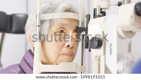 Old woman having her eyes examine