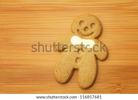 Gingerbread man cookie on wooden background
