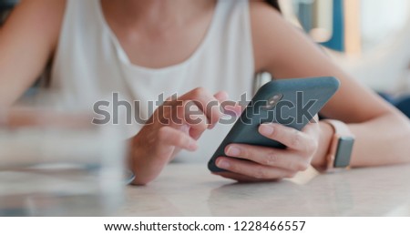 Woman use of mobile phone in coffee shop