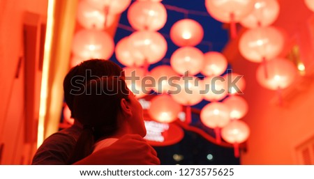 Couple enjoy looking at the red lantern at night