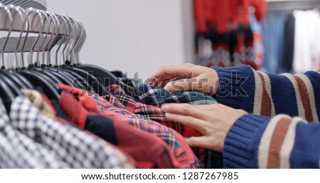 Woman shopping for clothes fashion designer browsing wardrobe